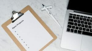 project manager stuff laptop pen paper
